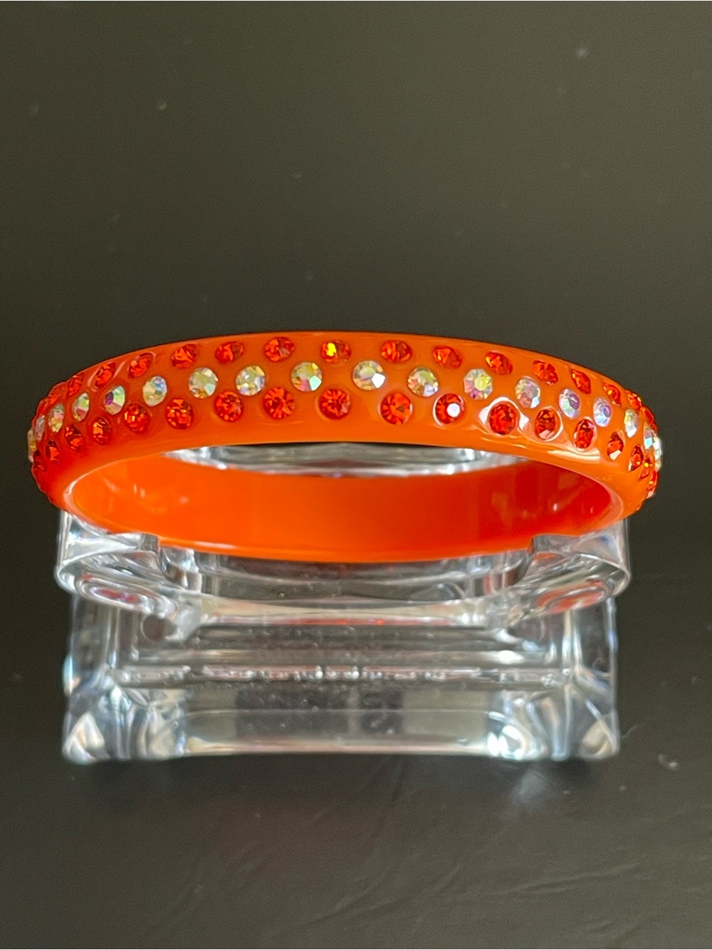 Vintage orange lucite and rhinestone bangle bracelet.